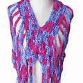 Vibrant magenta and periwinkle blue sleeveless crochet crop top with a V-neck, displayed in a relaxed bohemian style.
