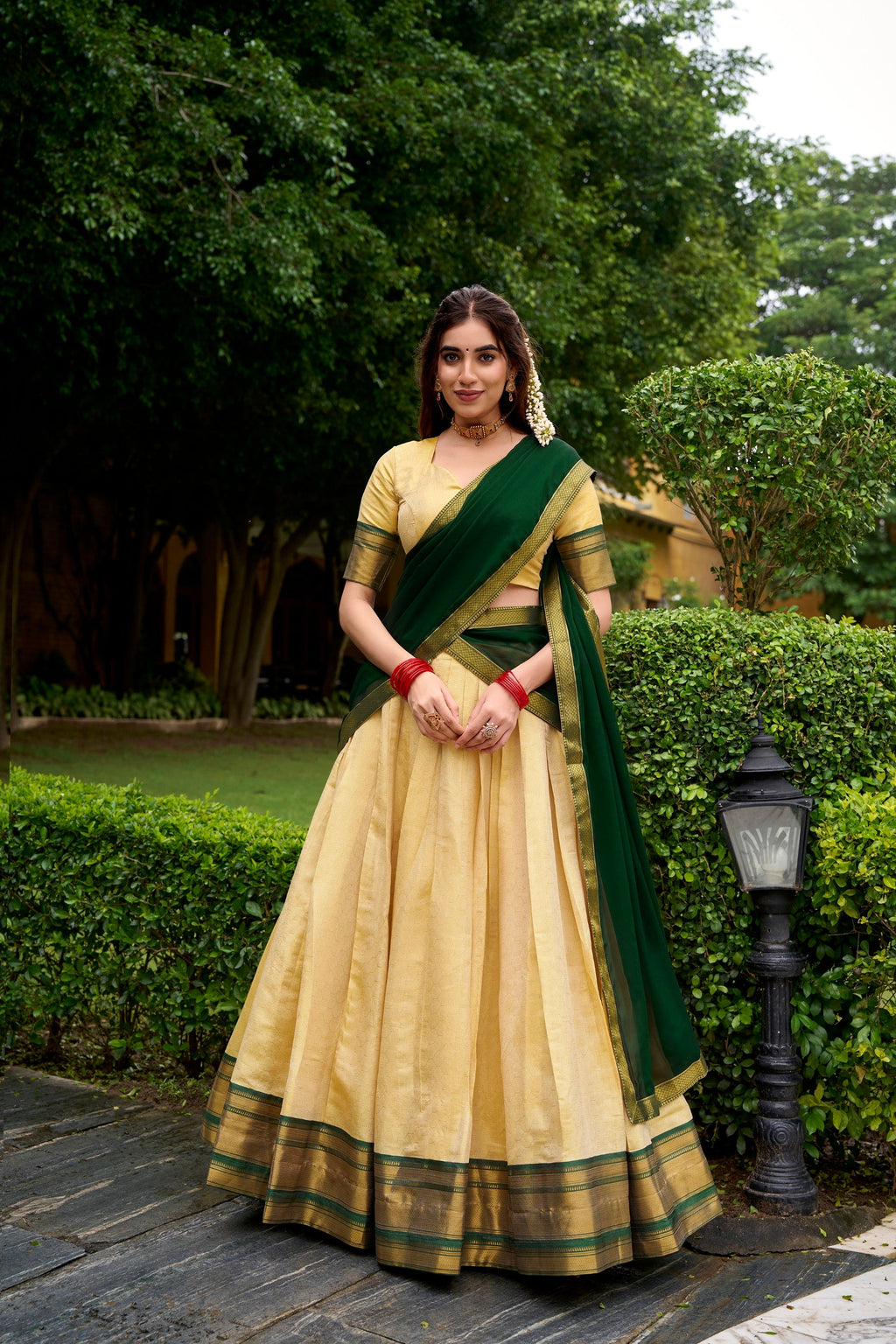 Cream Kanchipuram style lehenga choli with ornate gold Zari work