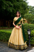 Cream Kanchipuram style lehenga choli with ornate gold Zari work