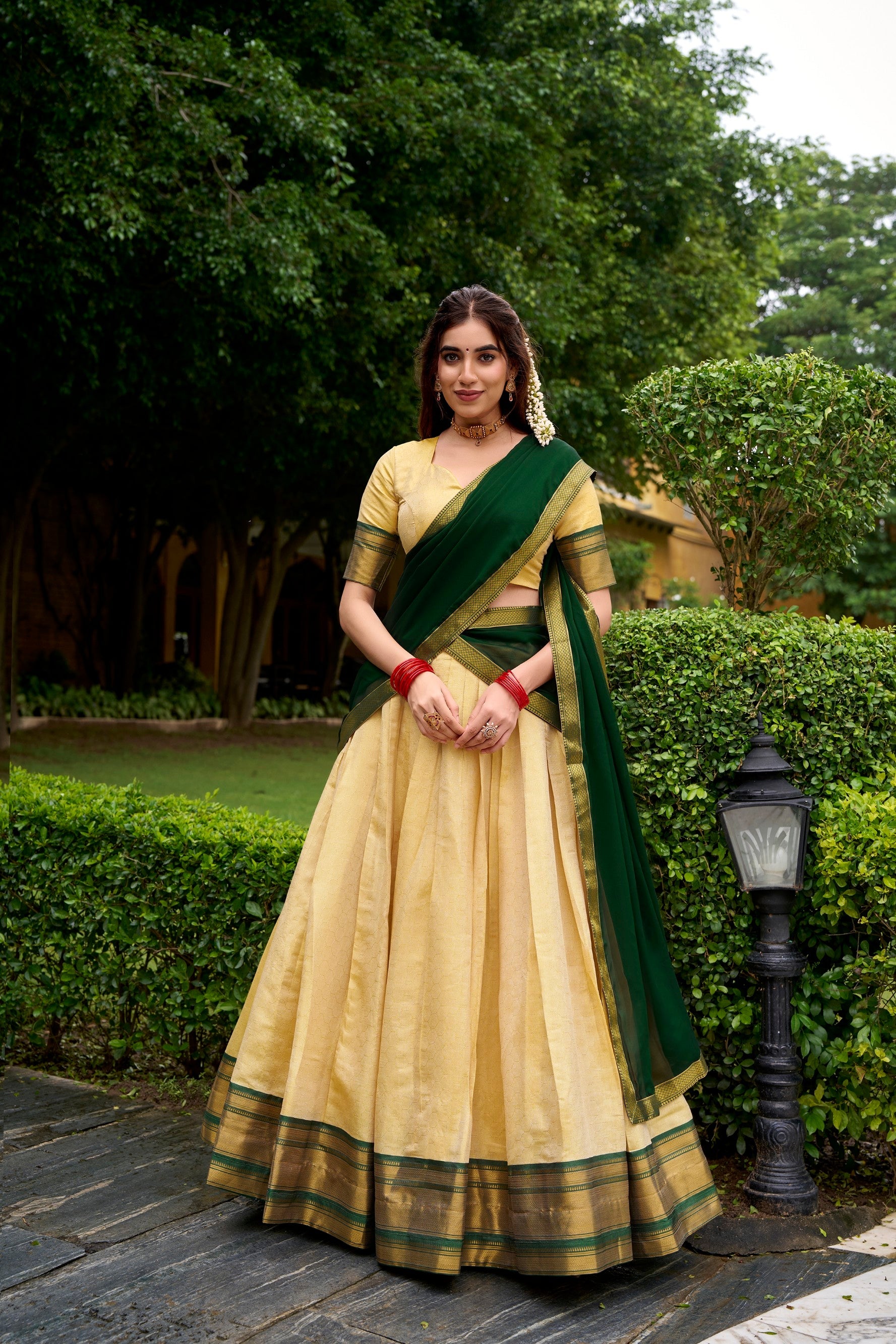 Cream Kanchipuram style lehenga choli with ornate gold Zari work