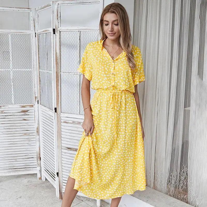 A high-waisted polka dot midi dress made from soft crepe fabric