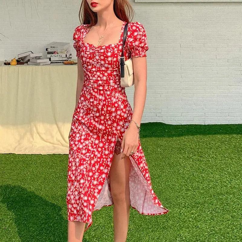 Woman wearing a romantic floral square neck summer dress in red and white