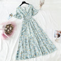 Woman wearing a floral print ruffled chiffon midi dress with a V-neck and high waist