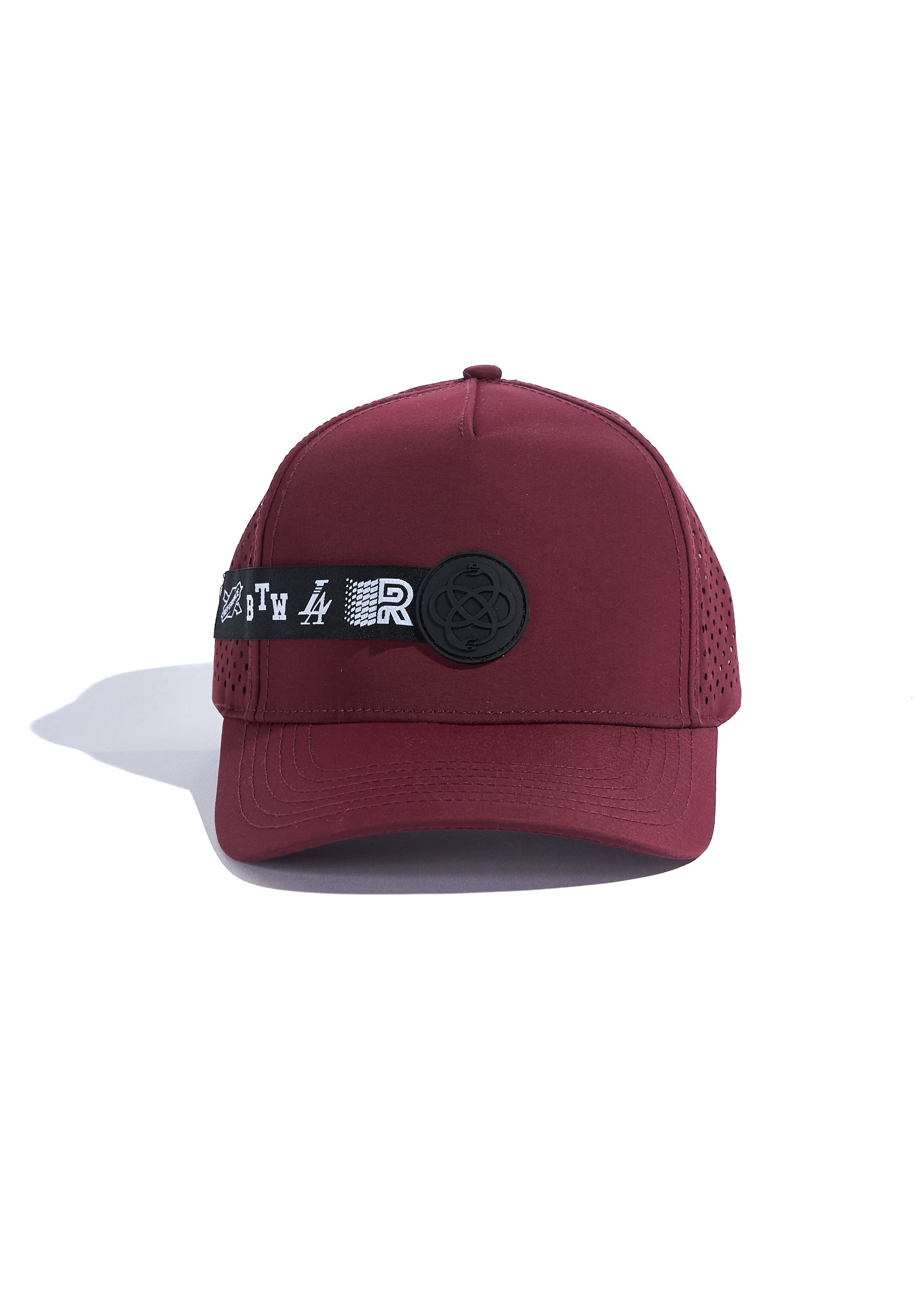 A wine-colored performance baseball cap with a perforated back, rubber logo patch, and branded strap detail.