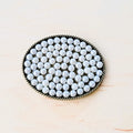 Oval shaped antique gold-tone belt buckle with a rope border and white pearl bead inlay