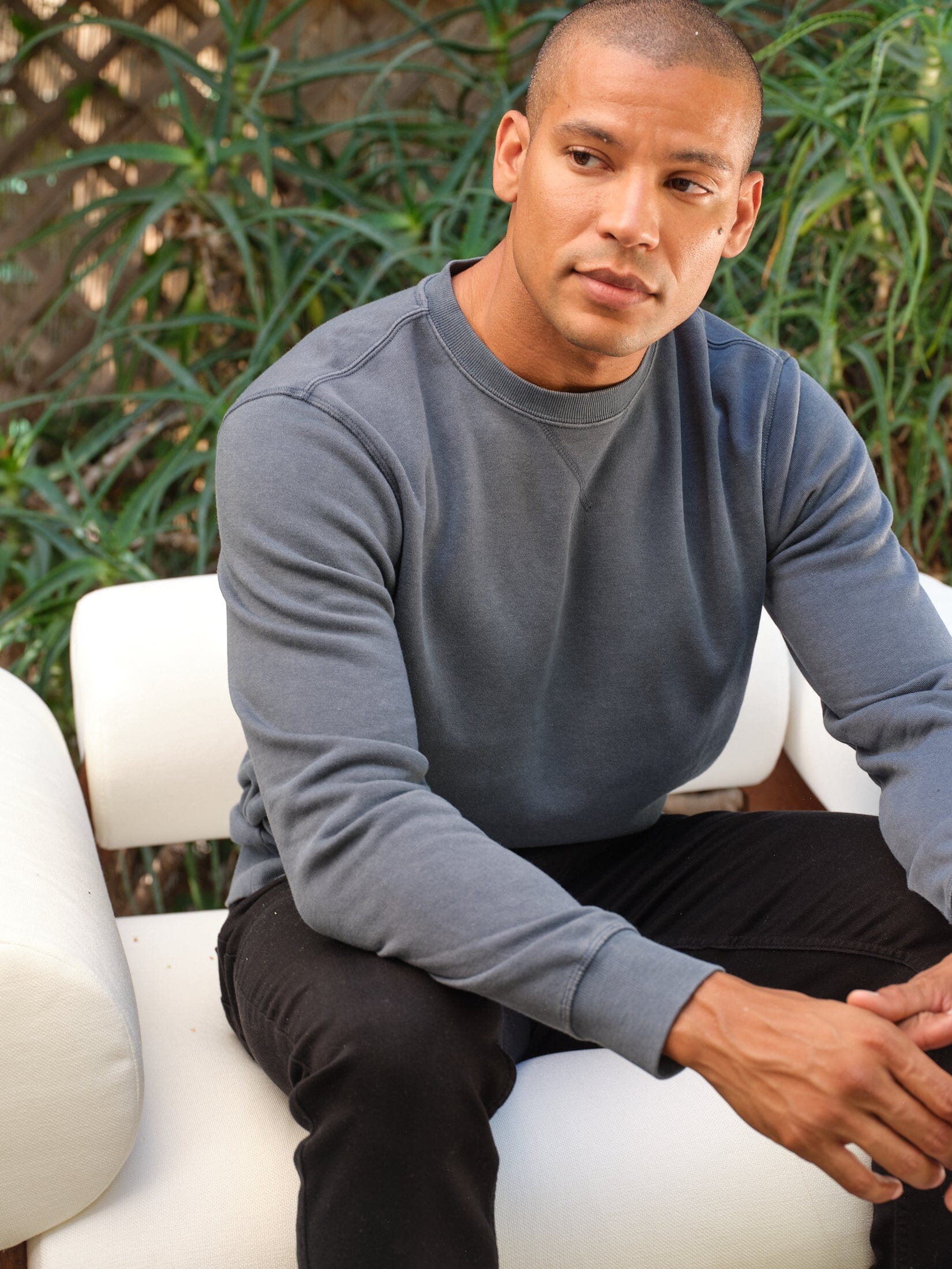 Model wearing a grey Mineral Wash Fleece Crew with visible mineral wash texture