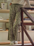 Woman wearing Eila wide-leg cargo pants in olive green and cream floral print with utility pockets