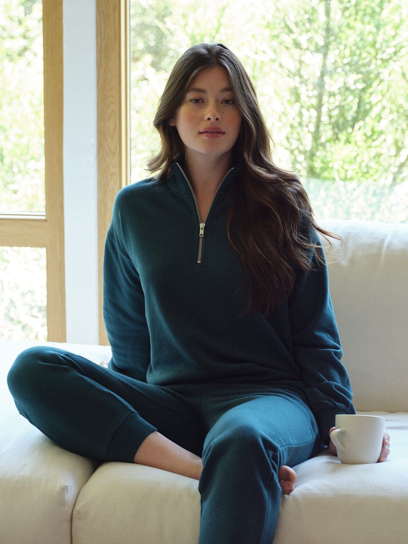 Women wearing Constance Triblend Fleece Half Zip Pullover in teal, solid knit texture