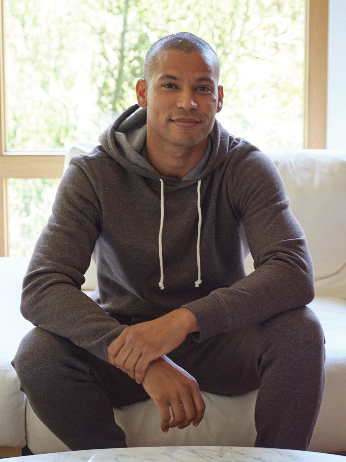 Men's Core triblend fleece pullover hoodie in brown and heathered grey, minimalist sporty design.