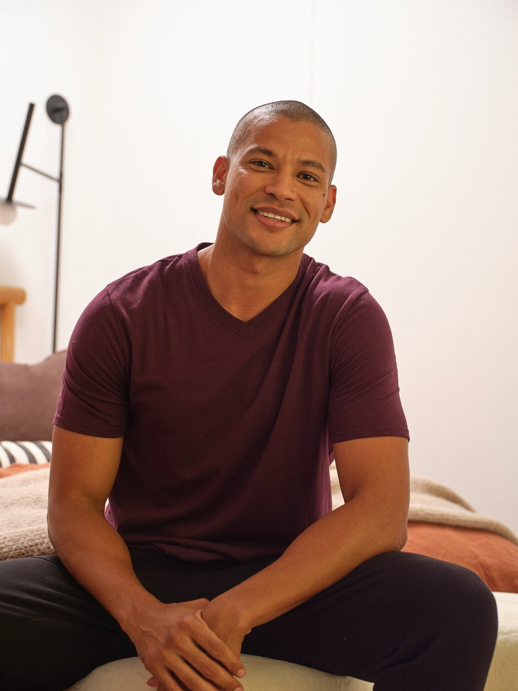 Men's dark purple and maroon triblend V-neck tees in solid knit fabric.