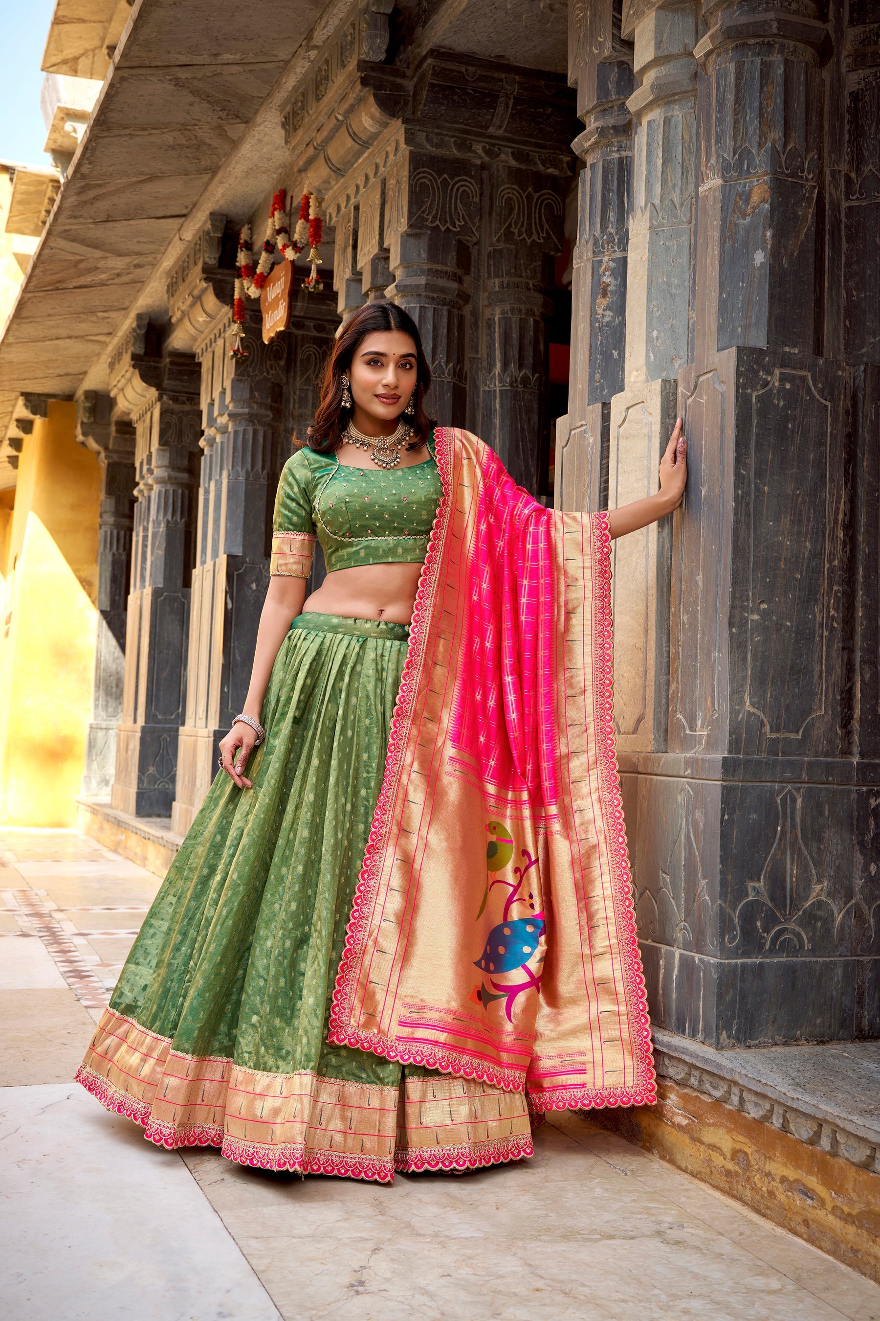 Green Simmer Organza lehenga featuring zari weaving and lace border detail