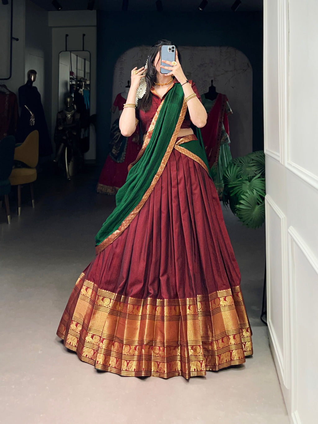 Woman wearing a Maroon Narayan Pet Silk lehenga choli with traditional gold Zari weaving work