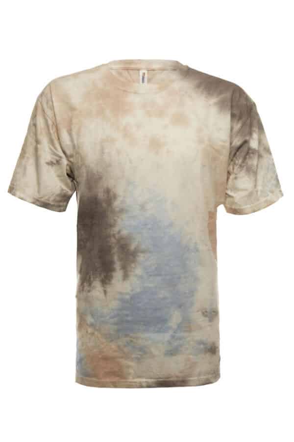 A close-up view of a hand-dyed Snow Splash tie dye t-shirt featuring muted blue, brown, and cream tones on a soft cotton fabric.
