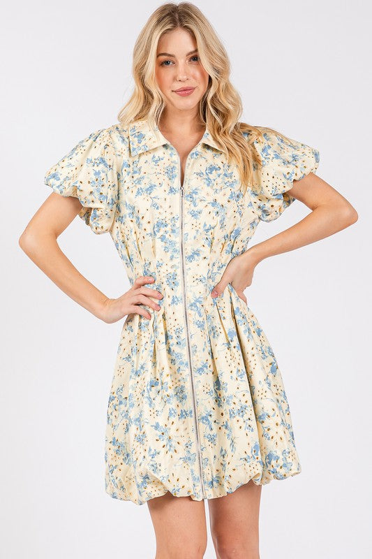 Mini dress with floral eyelet pattern, front zipper, and puff sleeves