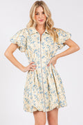 Mini dress with floral eyelet pattern, front zipper, and puff sleeves