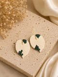 Handmade Alocasia Regal Shields Albo botanical earrings in cream and dark-green polymer clay.
