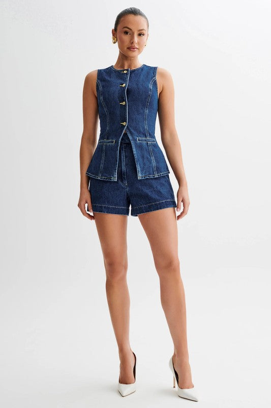 A woman wearing a stylish denim two-piece matching set, showcasing the top and bottom fit.
