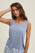Model wearing a lightweight M. Blue sleeveless sweater tank top made from soft viscose knit fabric.