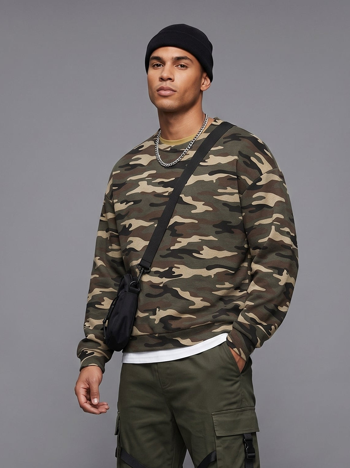 An oversized woodland camo crewneck sweatshirt with dropped shoulders and ribbed cuffs.