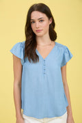 Light blue chambray top with V-neck, half-button front, and ruffle sleeves.
