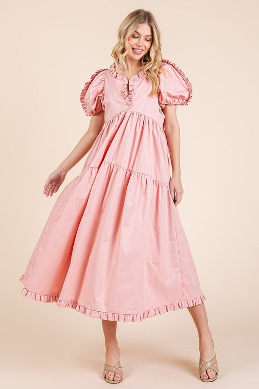 A feminine tiered babydoll midi dress with ruffle trim and puff sleeves.