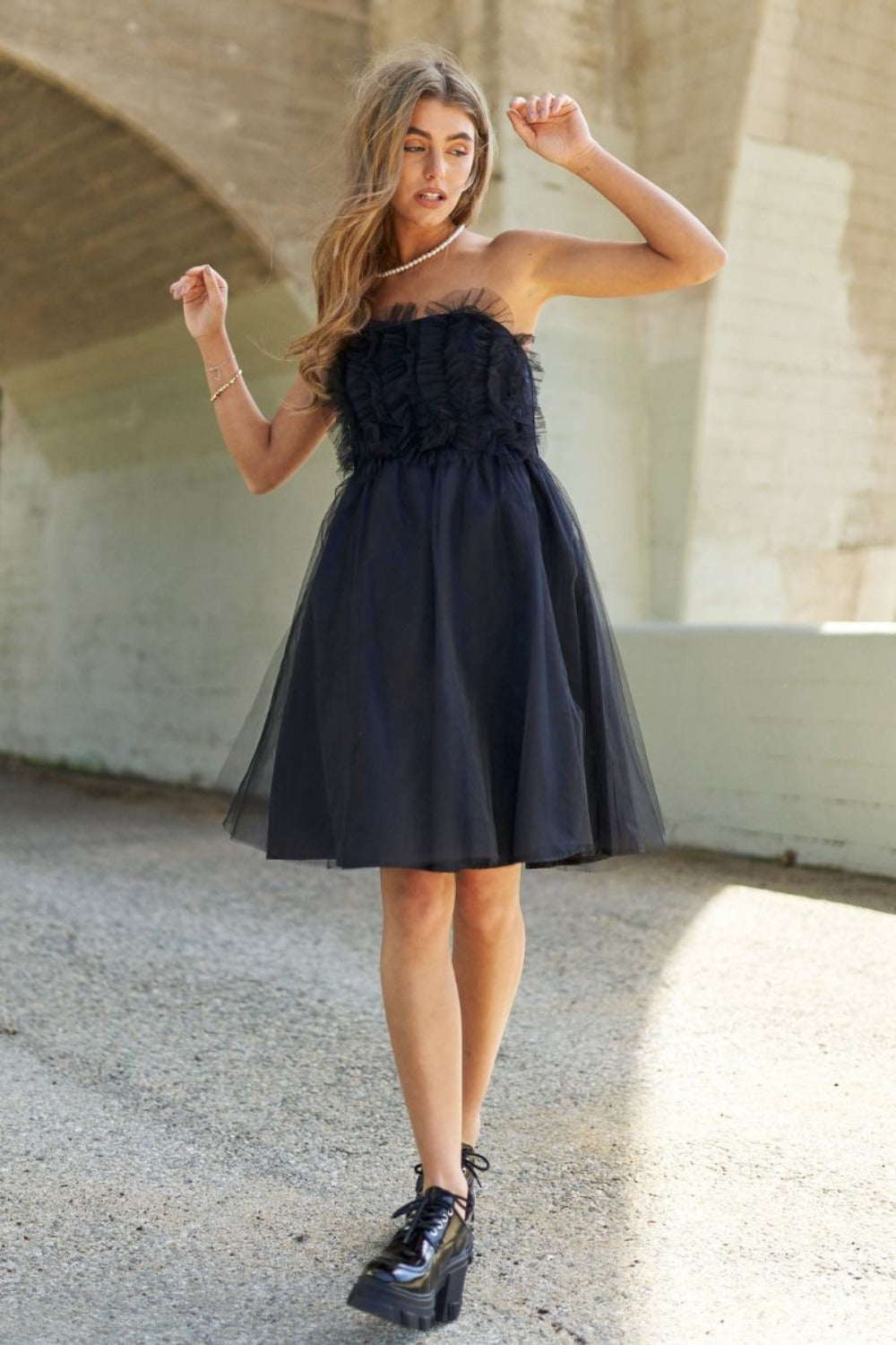 Black mesh ruffle tube top swing dress with a flattering flutter hem.
