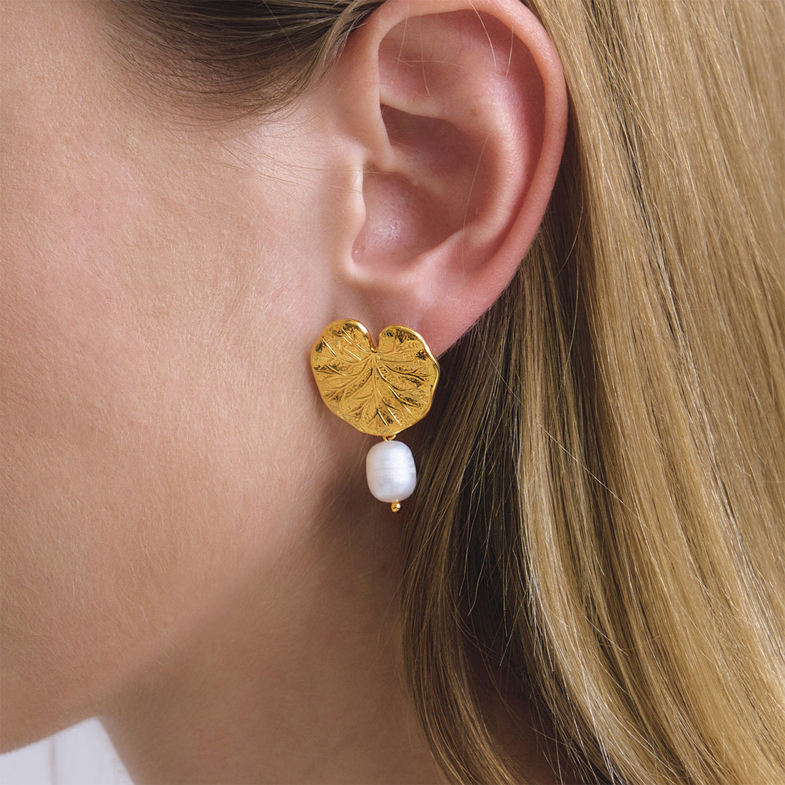 Gold-tone stainless steel lotus leaf drop earrings with white freshwater pearls
