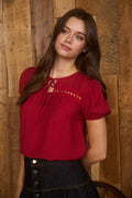 Vibrant red puff sleeve top with eyelet lace trim and double front tie detail
