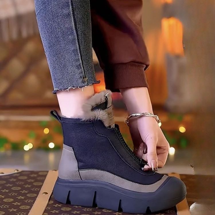 Women wearing lightweight black and gray front-zip ankle boots with faux fur lining, styled with jeans