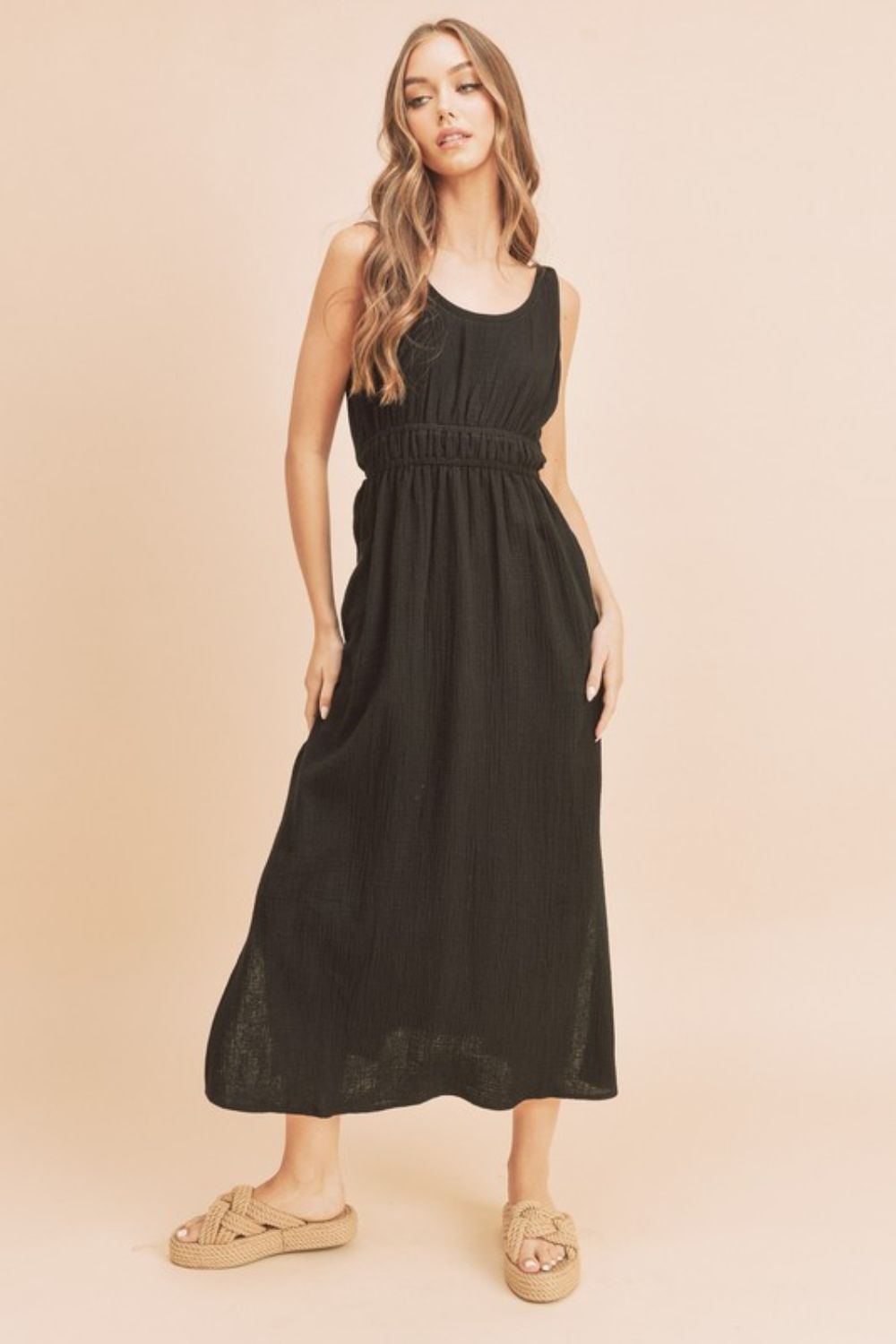 Black sleeveless cotton tank dress with side slits and round neckline