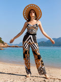 Elegant swimwear set in black, white, and gold tones, perfect for resort vacations.