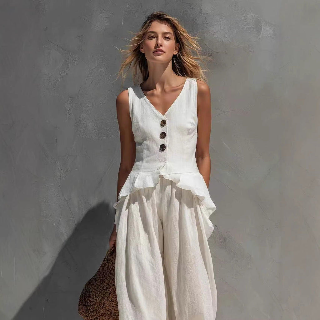 Model wearing a sleeveless button-front peplum top and matching wide-leg pants in black and white options.