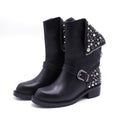 A pair of black punk-style combat boots featuring silver rivets, studs, a side zipper detail, and an adjustable buckle strap, displayed on a white background.