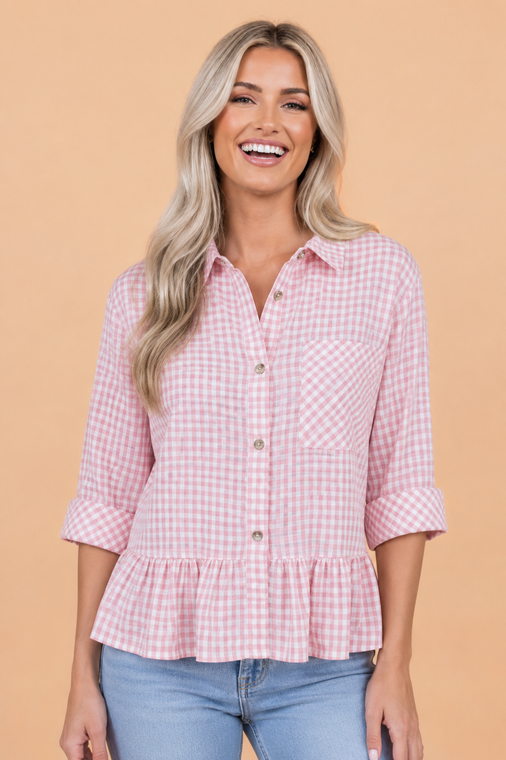 Women's pink and white gingham plaid shirt with 3/4 sleeves and ruffle hem detail