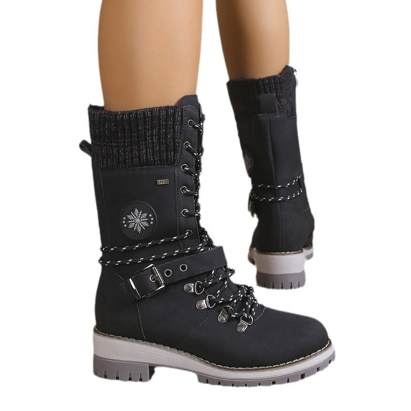 A pair of women's high-top winter snow boots featuring integrated fur lining, lace-up front, and decorative side buckle strap