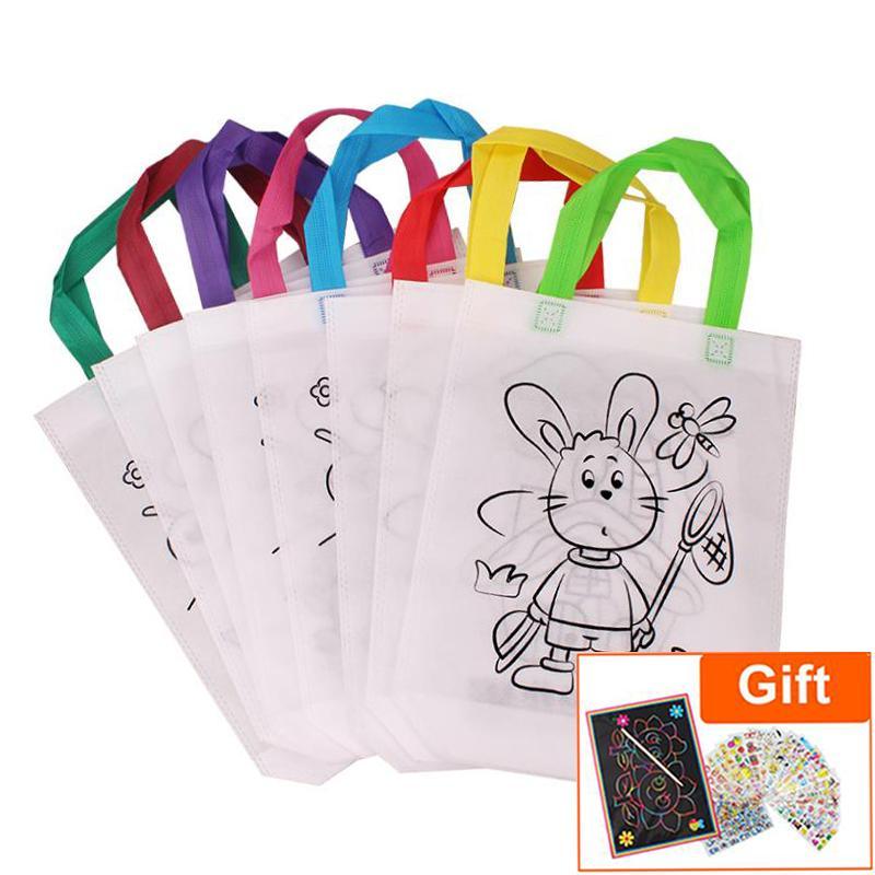 Set of 6 white DIY graffiti bags with black line art patterns and colorful handles for kids painting activity.