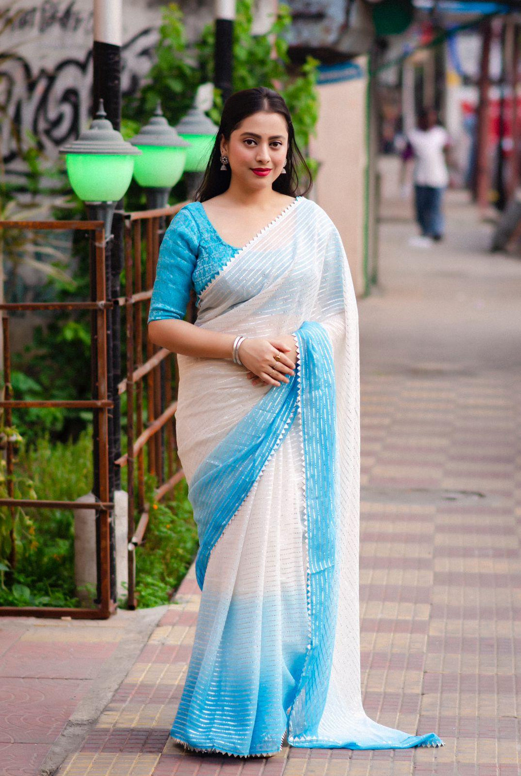 Blue poly chiffon striped saree with silver zari lining and matching tie-dye blouse