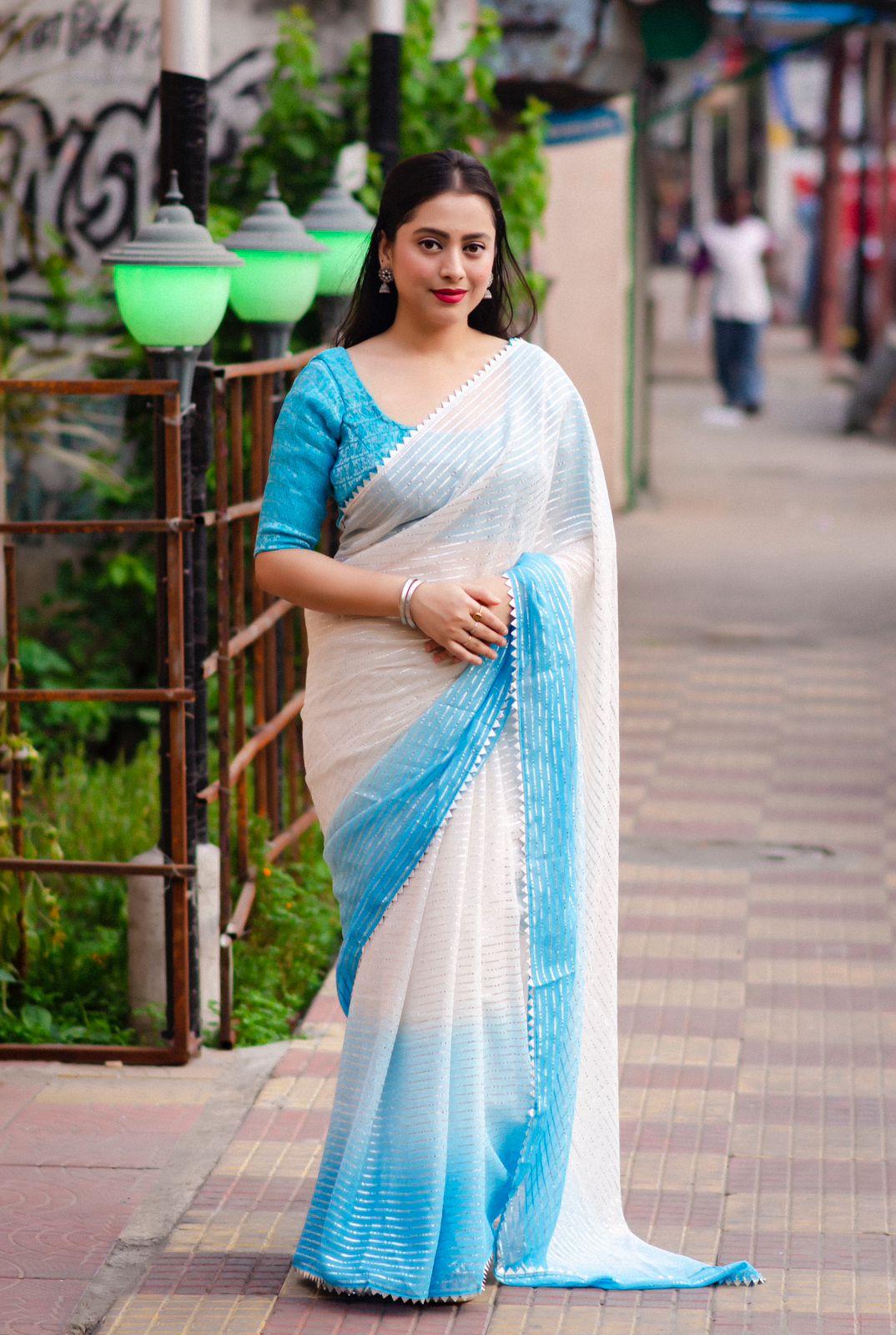 Blue poly chiffon striped saree with silver zari lining and matching tie-dye blouse