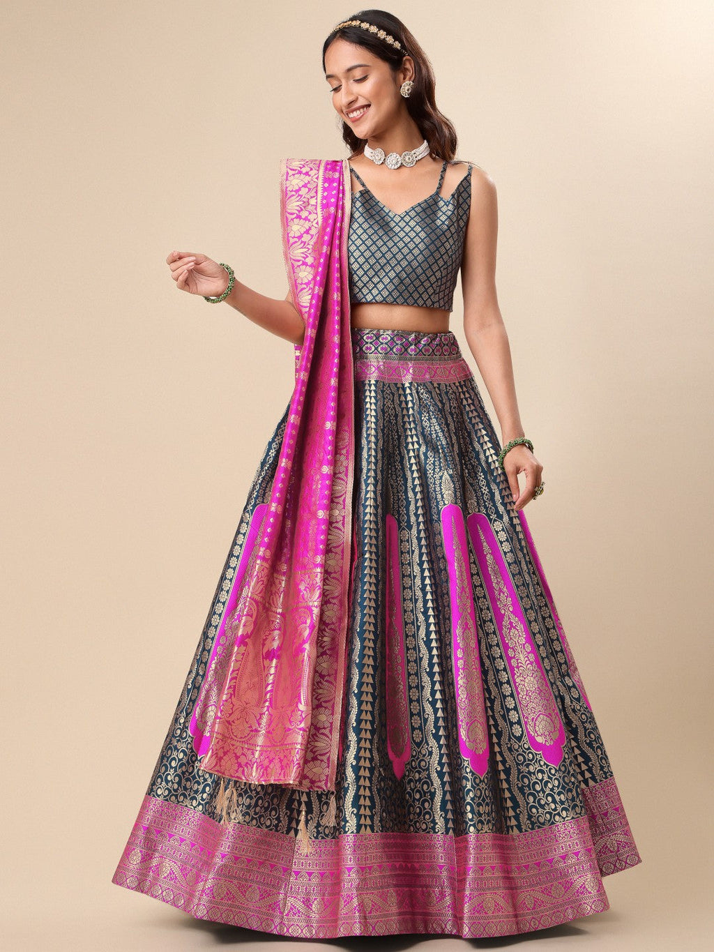 Woman wearing a teal and magenta geometric patterned silk ready to wear lehenga with dupatta