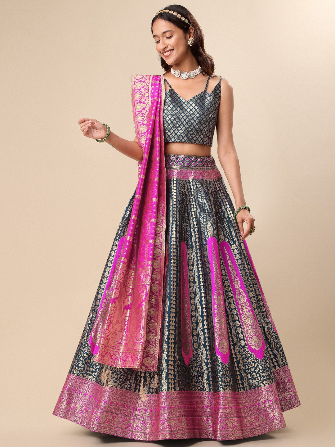 Woman wearing a teal and magenta geometric patterned silk ready to wear lehenga with dupatta