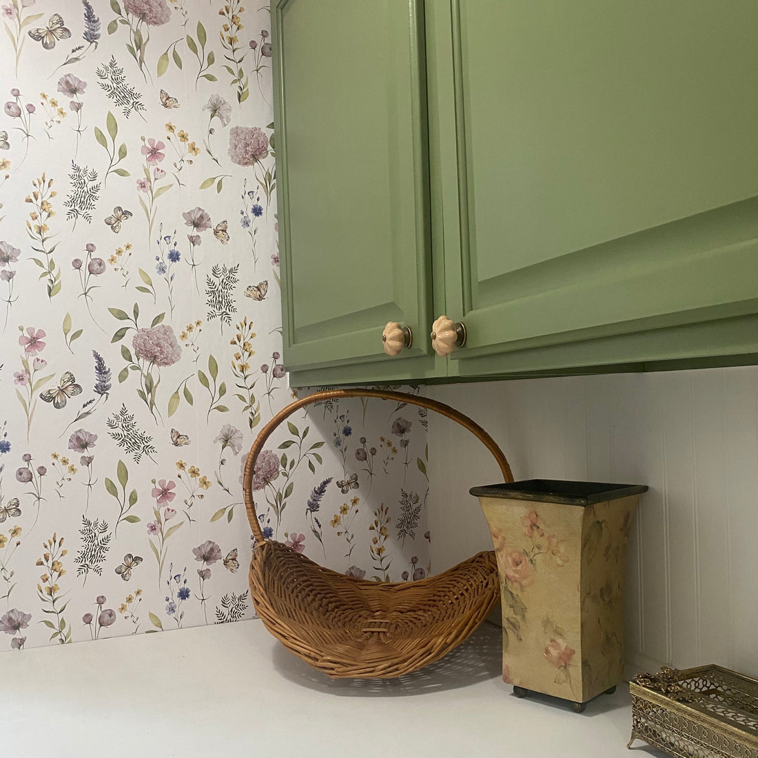 Valerie wallpaper featuring a botanical floral pattern in sage-green, blush-pink, and lavender on a white background.