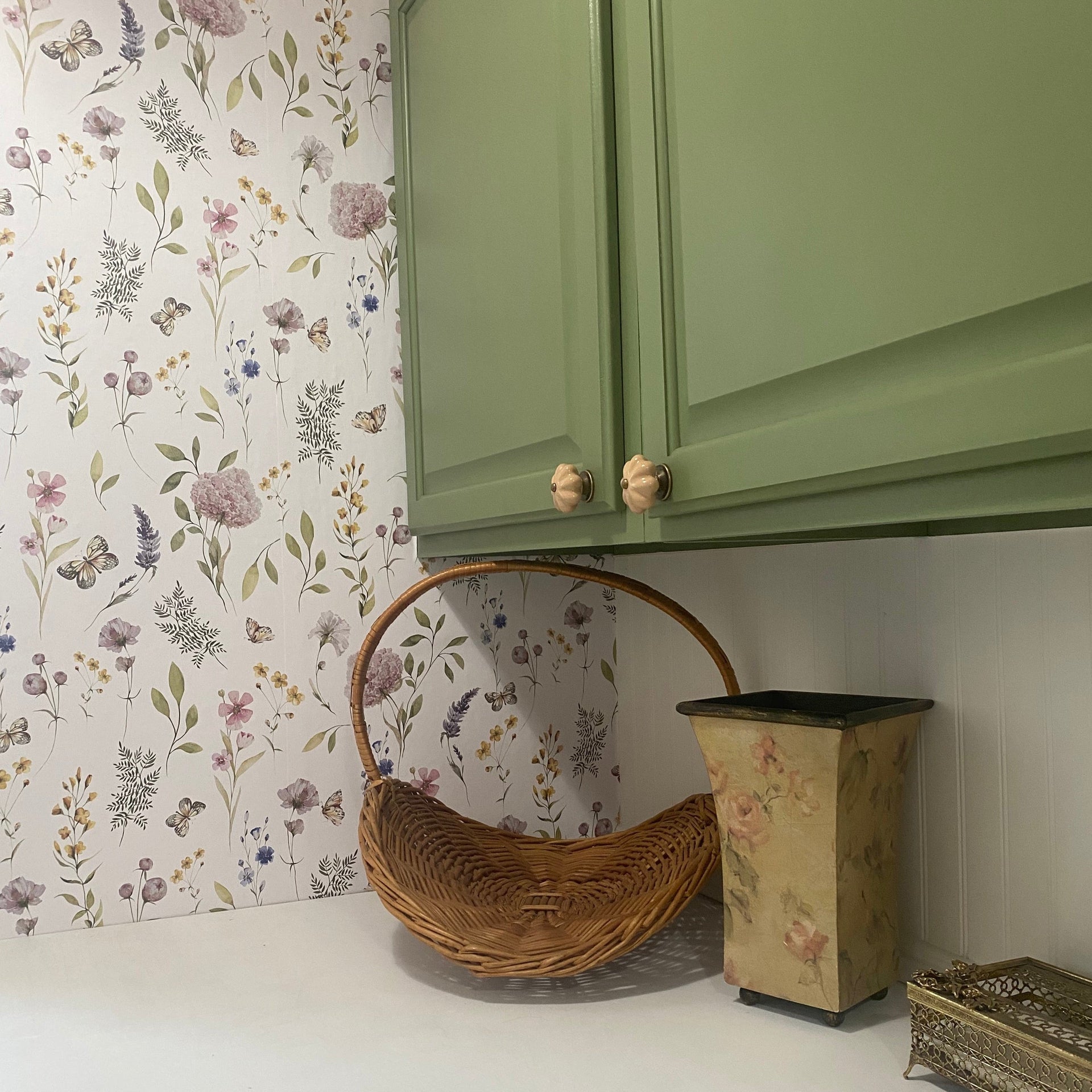 Valerie wallpaper featuring a botanical floral pattern in sage-green, blush-pink, and lavender on a white background.