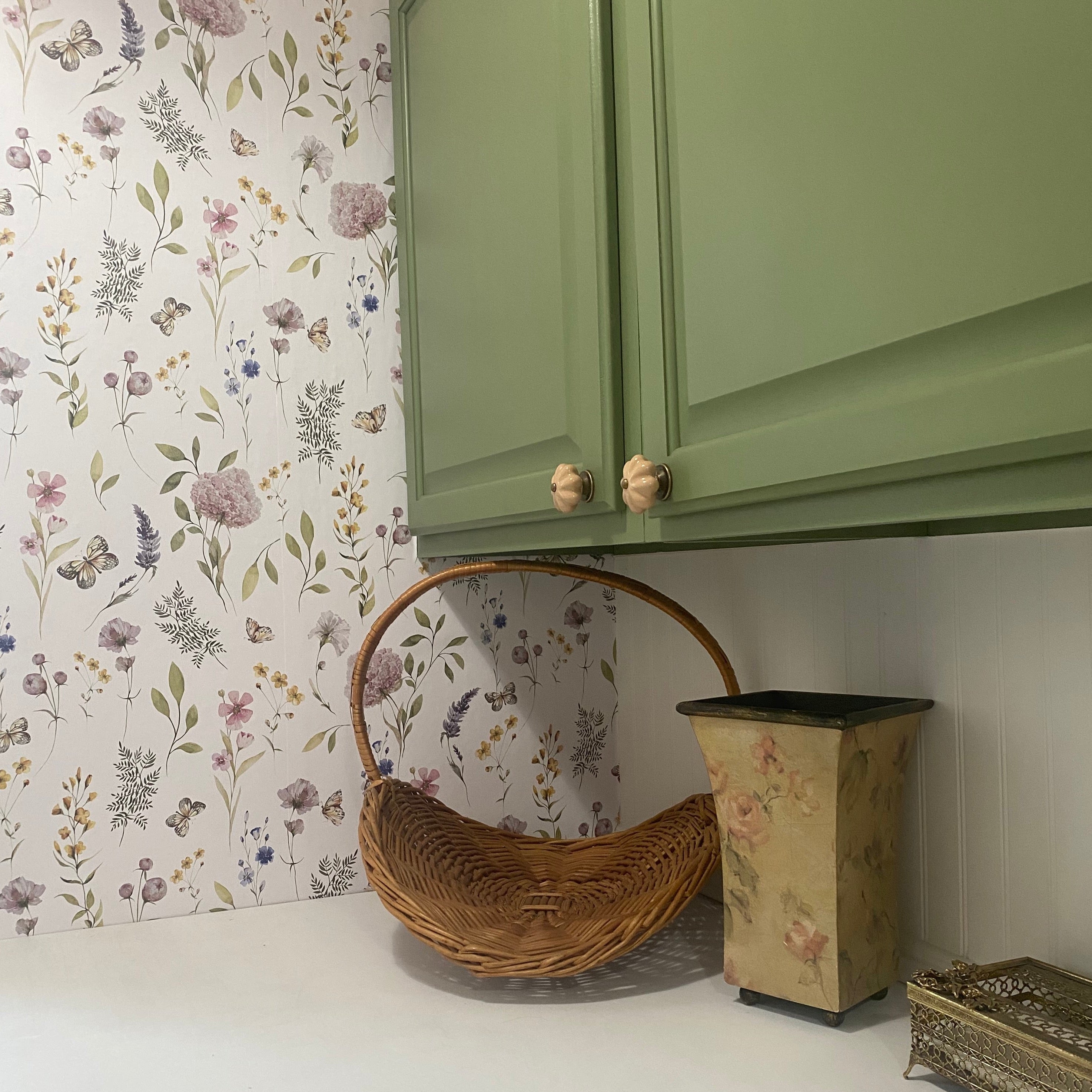 Valerie wallpaper featuring a botanical floral pattern in sage-green, blush-pink, and lavender on a white background.