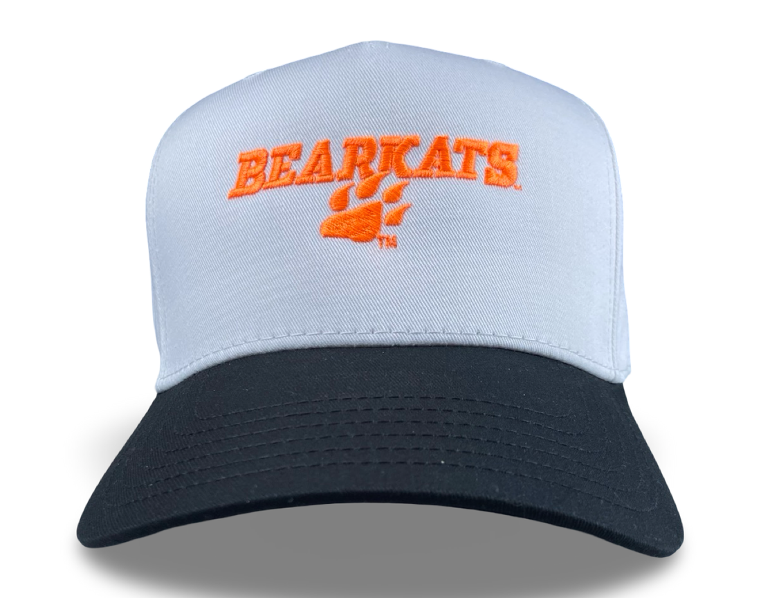 Bearkats paw print trucker hat with orange embroidery on a white mesh crown and navy bill.