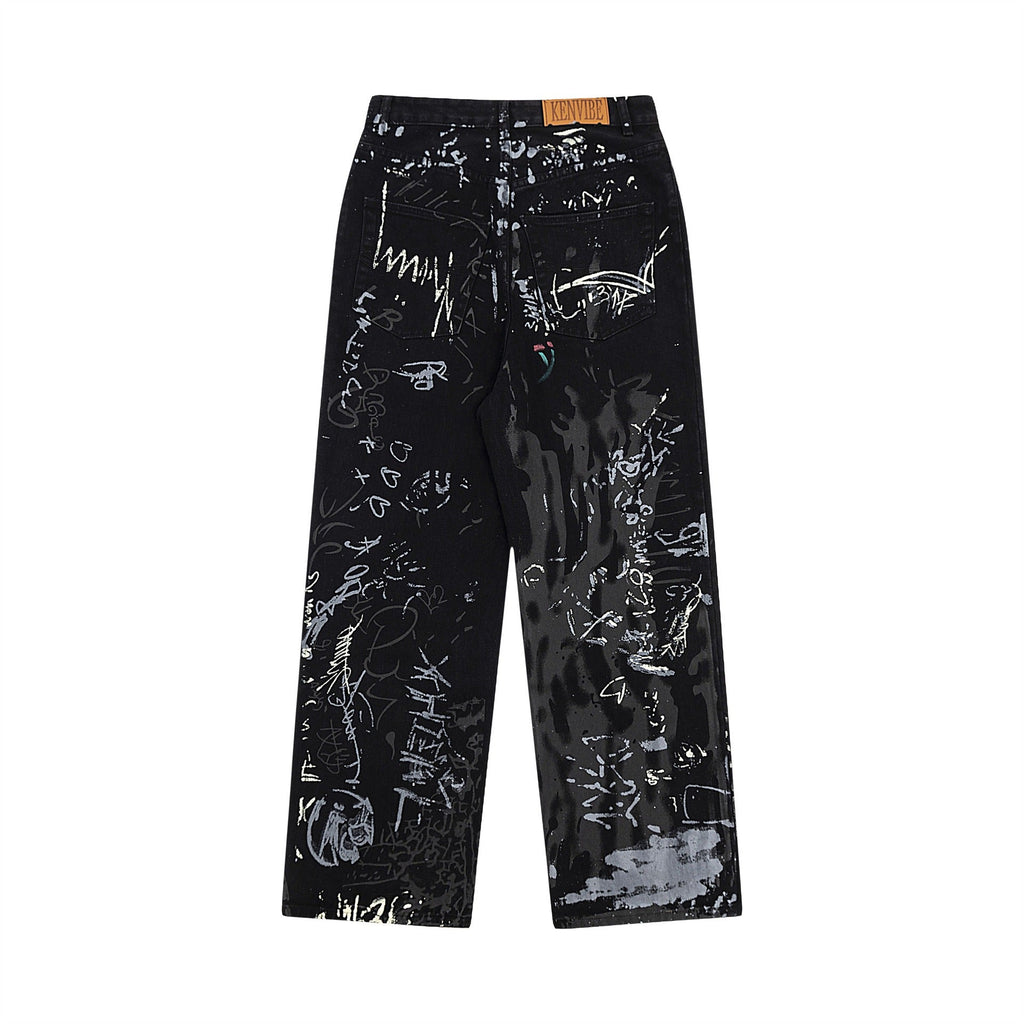Back view of black wide leg denim jeans with white graffiti print, featuring a 'KENVIBE' label on the waistband.