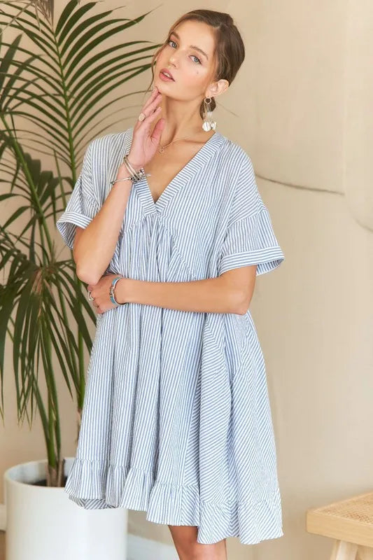 Striped V-neck babydoll dress with a ruffled hem and a fluttery, feminine silhouette.