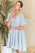Striped V-neck babydoll dress with a ruffled hem and a fluttery, feminine silhouette.