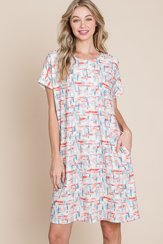 Woman wearing a casual printed round neck tee dress with short sleeves and pockets
