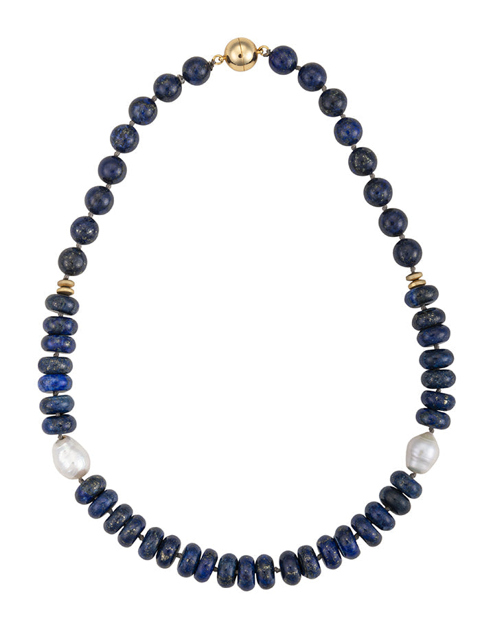 A 19-inch necklace featuring deep blue lapis lazuli beads, white freshwater Edison pearls, and small gold-tone hematite accents with a magnetic clasp.