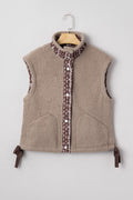 Tan sherpa fleece vest with brown and white floral trim, front button closure, and side ribbon bows.